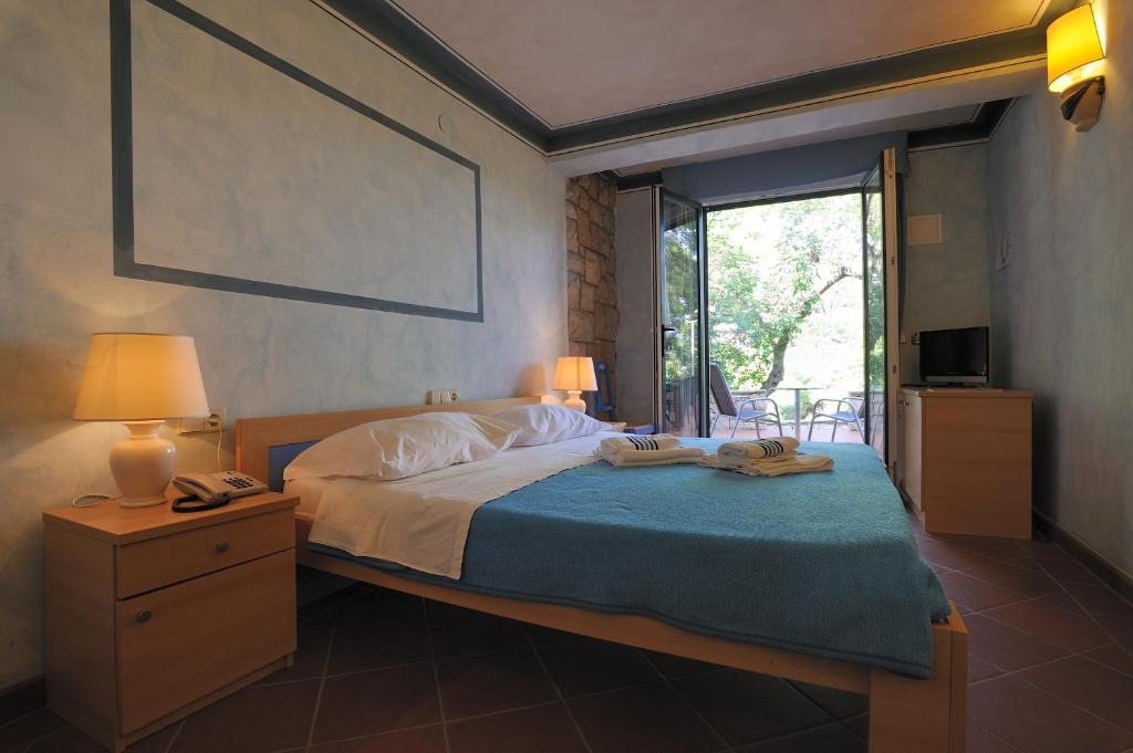 Postel nebo postele na pokoji v ubytování Hotel Solitudo