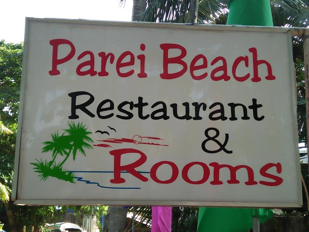 a sign for a maribel beach restaurant and rooms at Parei Beach Inn in Tangalle