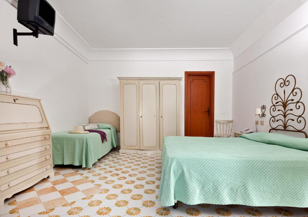 Postel nebo postele na pokoji v ubytování Hotel Vittoria