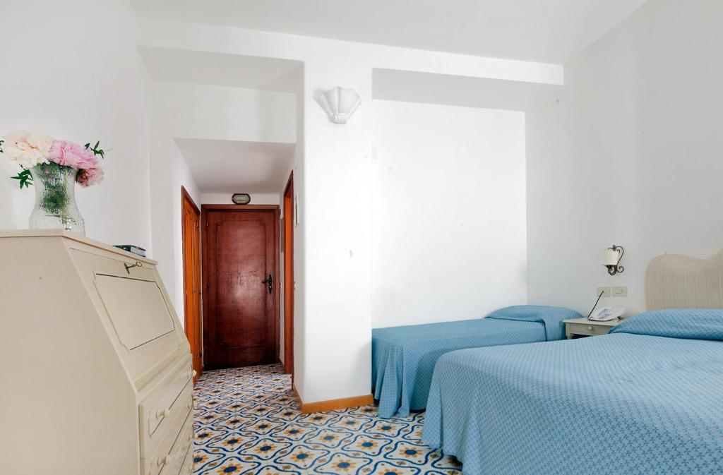 Postel nebo postele na pokoji v ubytování Hotel Vittoria