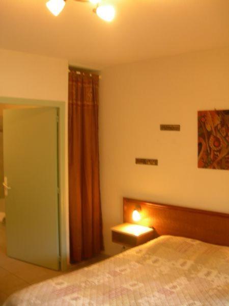 Postel nebo postele na pokoji v ubytování Hôtel de la Madeleine Anduze
