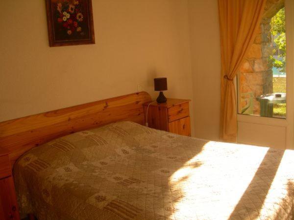 Postel nebo postele na pokoji v ubytování Hôtel de la Madeleine Anduze