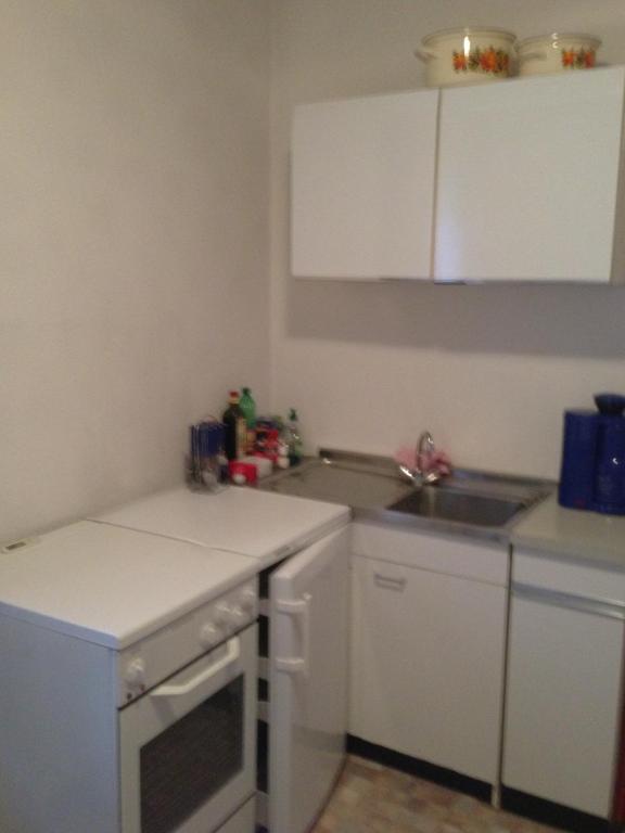 a small kitchen with a sink and a stove at Pension Freund in Rothenburg ob der Tauber