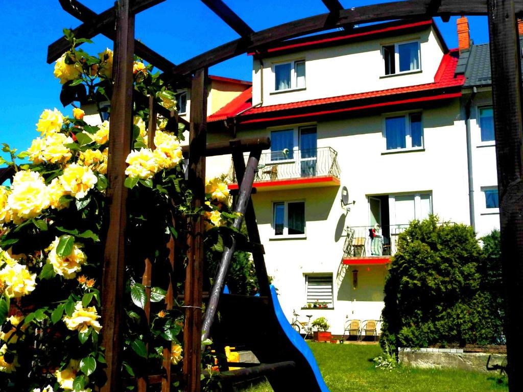 a playground with a slide in front of a building at Dom Wczasowy Olivia in Ustka