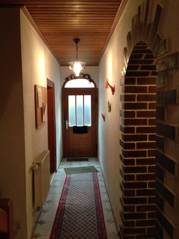 a hallway with a brick wall and a door at Pension Freund in Rothenburg ob der Tauber