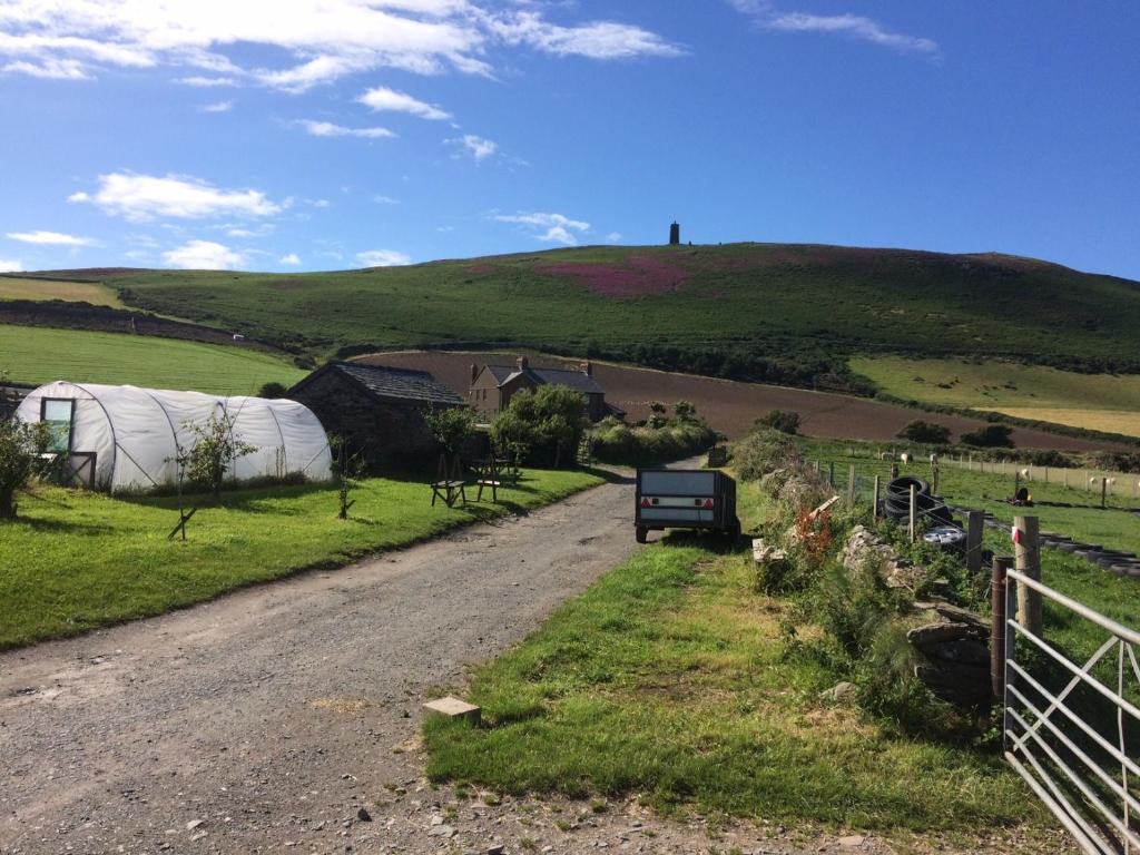 a dirt road leading to a farm with a tent at Knockaloe Beg Farm in Patrick