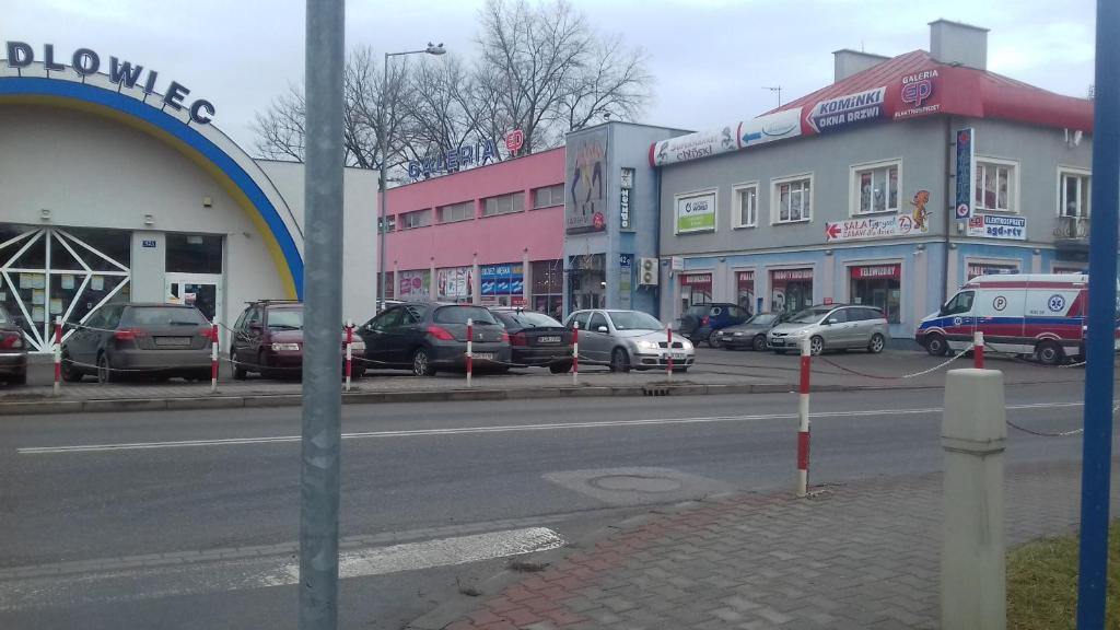 a city street with cars parked in front of buildings at Pokoje-Gorlice-Zawodzie in Gorlice