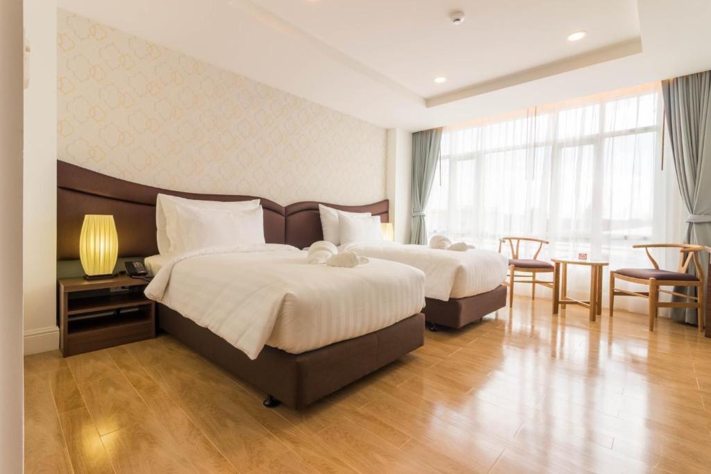 Postel nebo postele na pokoji v ubytování Avada Hotel