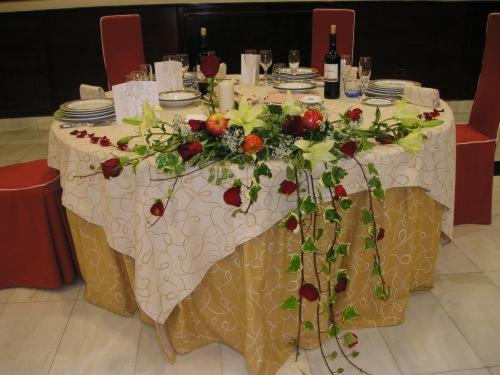 a table with a white table cloth and flowers on it at Hotel Begoña Park in Gijón