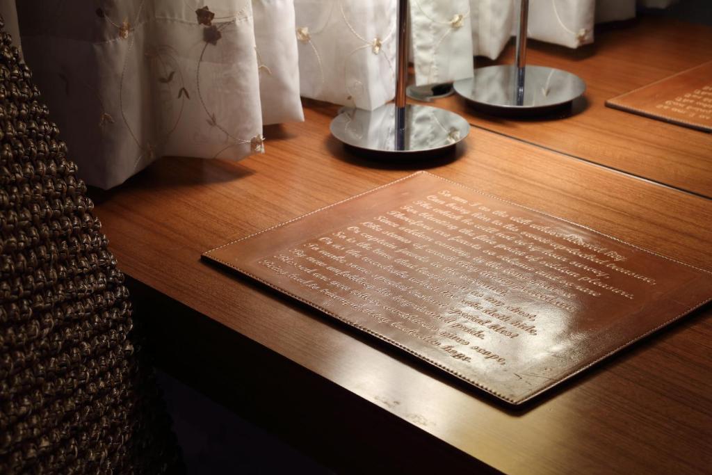 a wooden table with a plaque on top of it at In One City Inn in Taichung