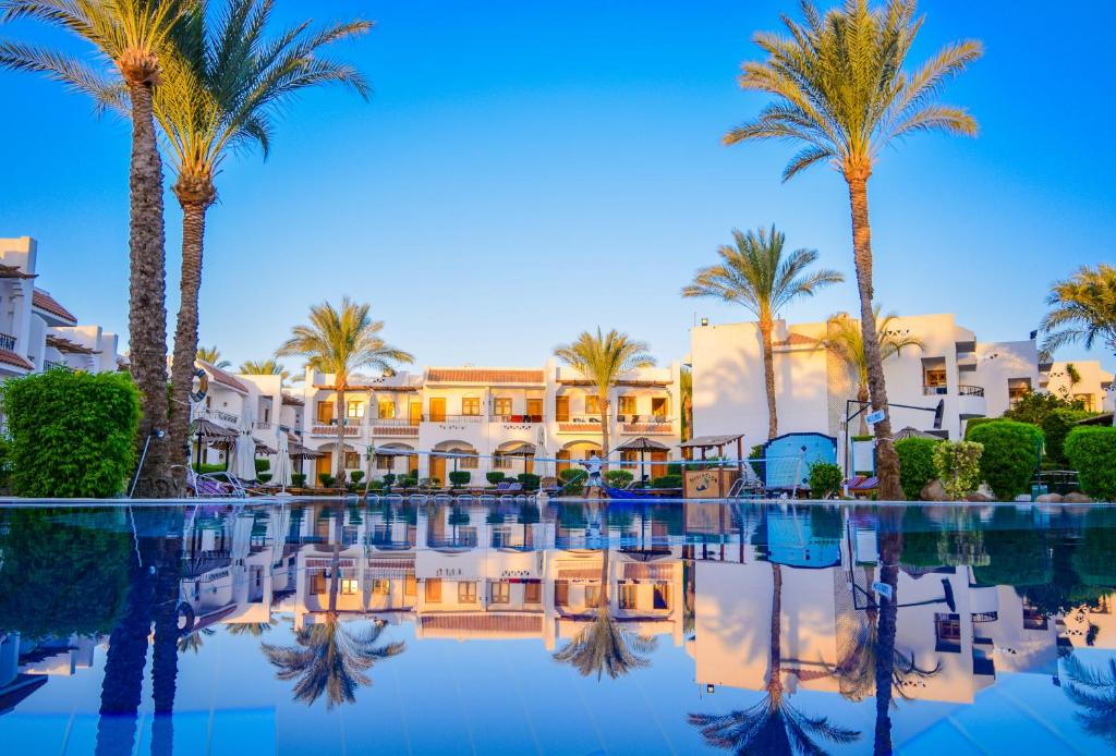 a resort with palm trees and a pool at Dive Inn Resort in Sharm El Sheikh