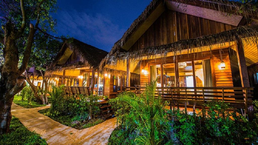 a resort building with a pathway in front of it at Bora Bora Villa Phuket in Chalong