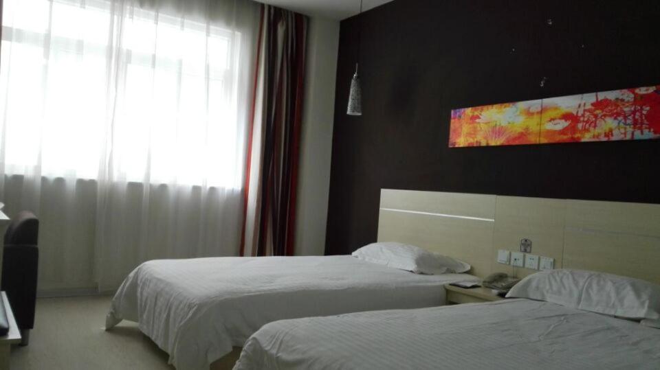 a hotel room with two beds and a window at Thank Inn Chain Hotel Hebei Shijiazhuang Lingshou Town Wanhao in Xituo