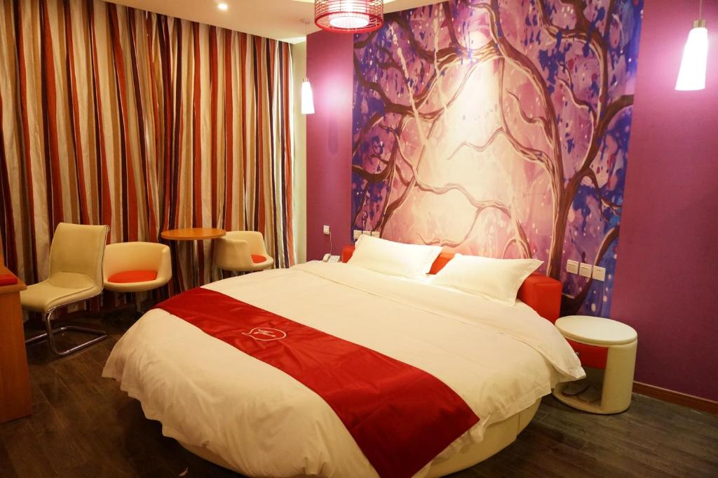 Thank Inn Chain Hotel Hunan Loudi New Huaxuefu Road في Dongling: غرفة نوم بسرير كبير وجدار ارجواني