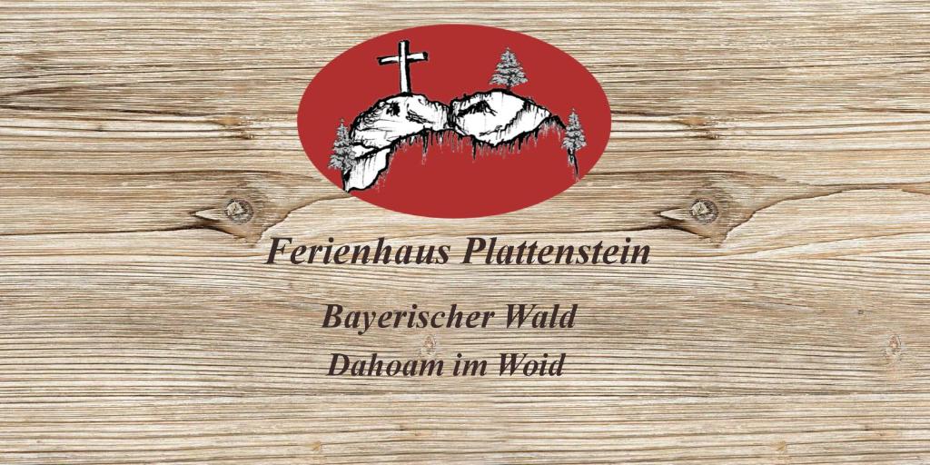 a red button with a cross on a wooden wall at Ferienhaus Plattenstein in Kirchberg