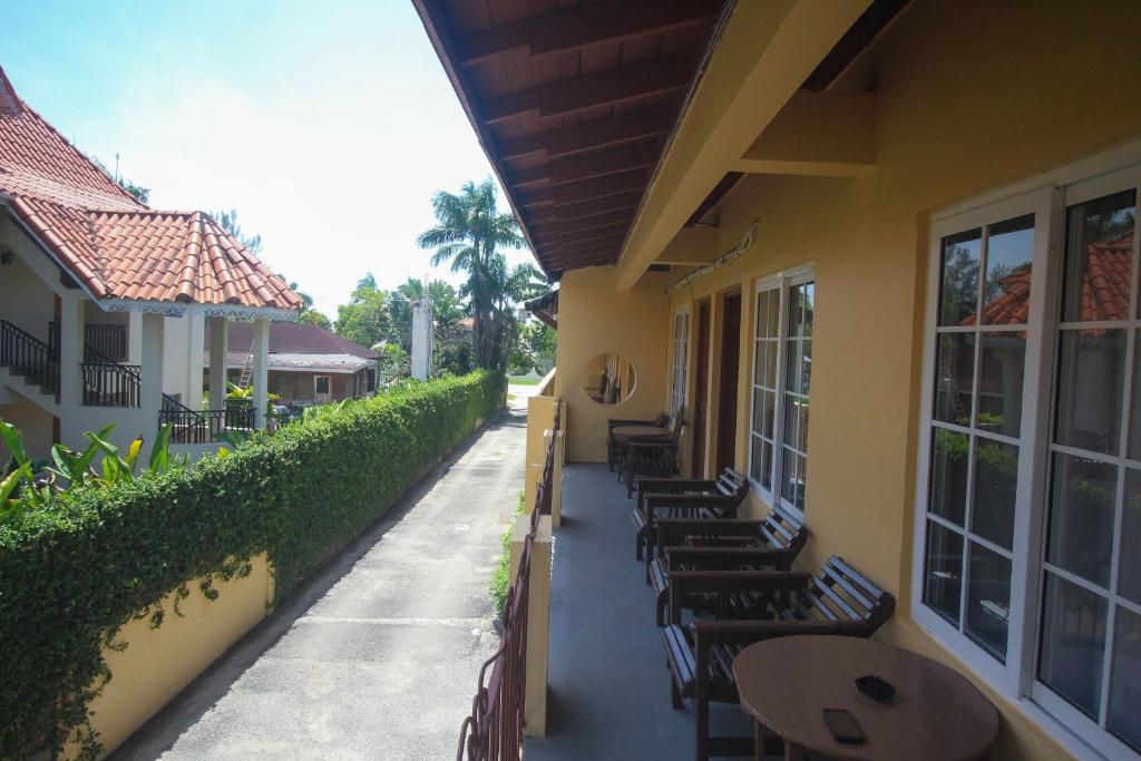 a row of tables and chairs on the side of a building at Moonrisevillas in Negril