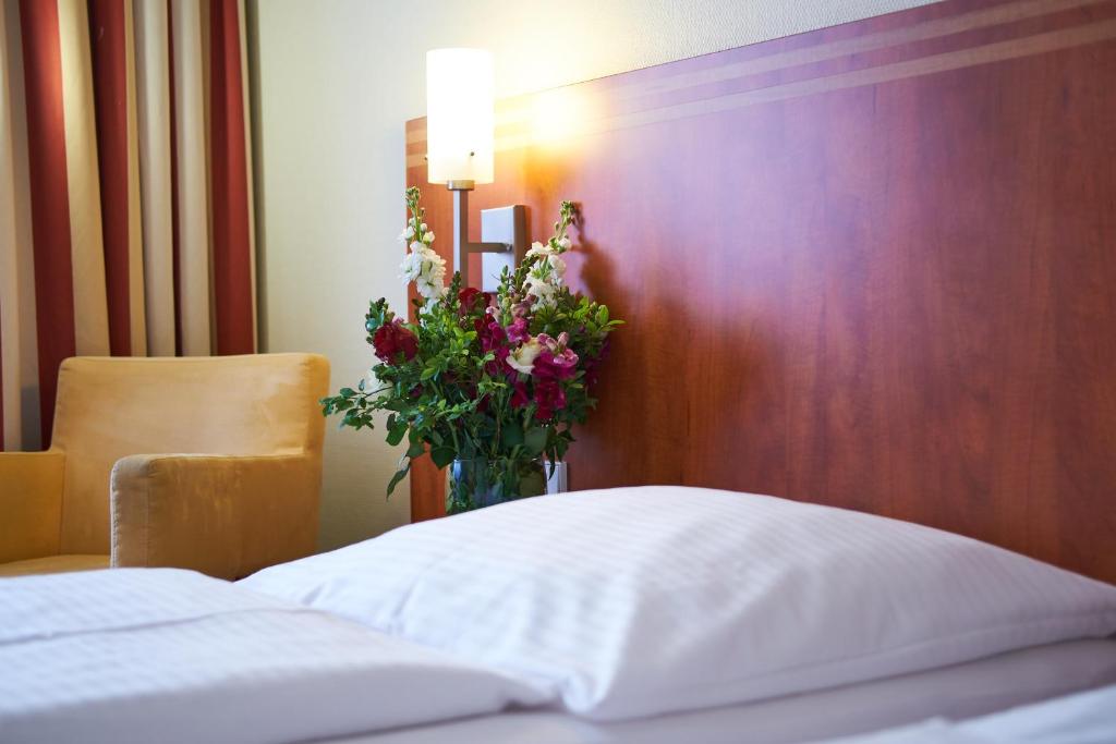 Postel nebo postele na pokoji v ubytování Hotel Concorde