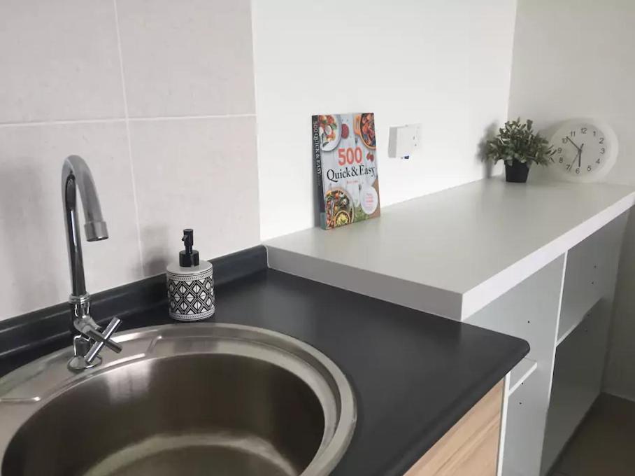 a silver sink in a kitchen with a counter at Damaye Evo Soho Suites in Central Bangi in Kampong Sungai Ramal Dalam