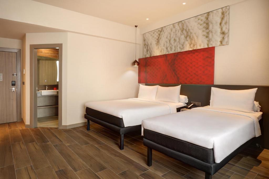 Uma cama ou camas num quarto em Ibis Melaka