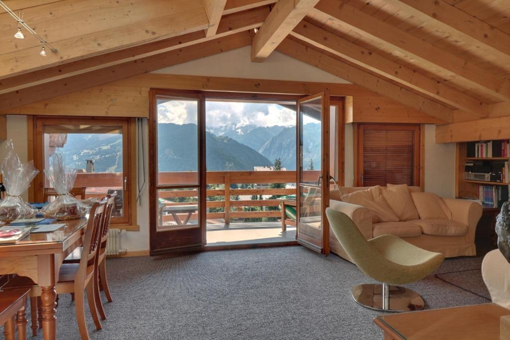 a living room with a view of the mountains at Olympia 443 in Verbier
