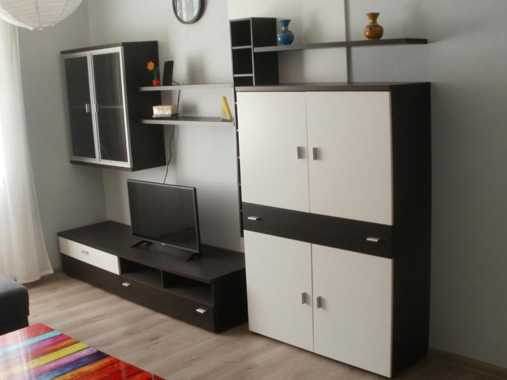 a bedroom with a black and white cabinet and a tv at Apartmán Abertamy Krušné hory in Abertamy