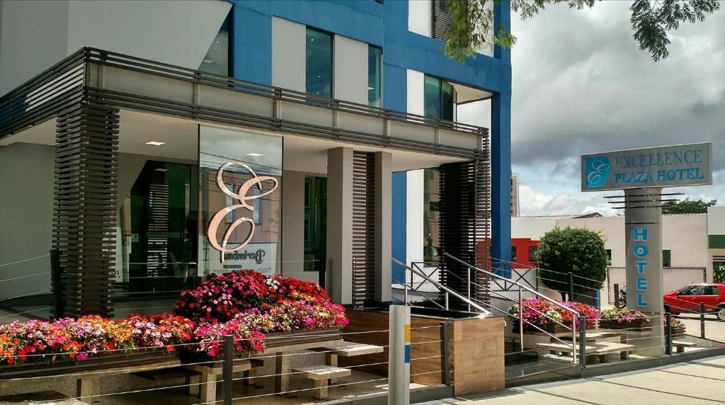 a large building with flowers in front of it at Excellence Plaza Hotel in Botucatu