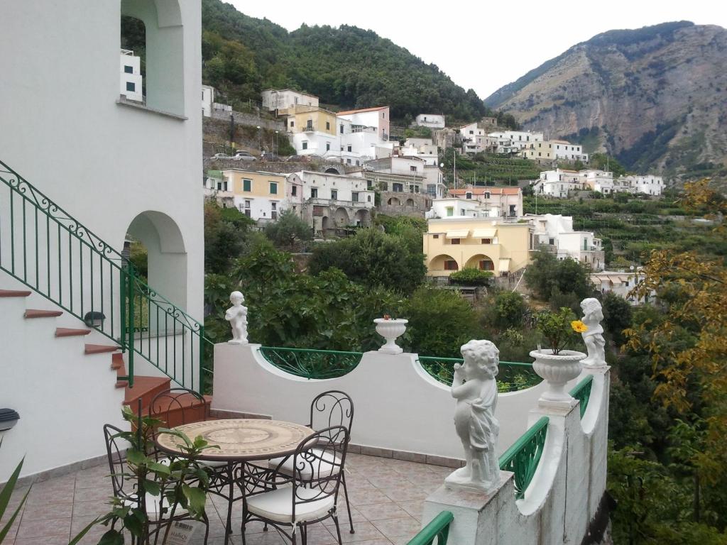 a balcony with a table and chairs and a view at Gerry house in Amalfi