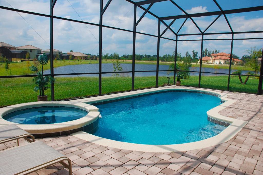 a swimming pool in a house with a view of a lake at Lake View Villas in Kissimmee