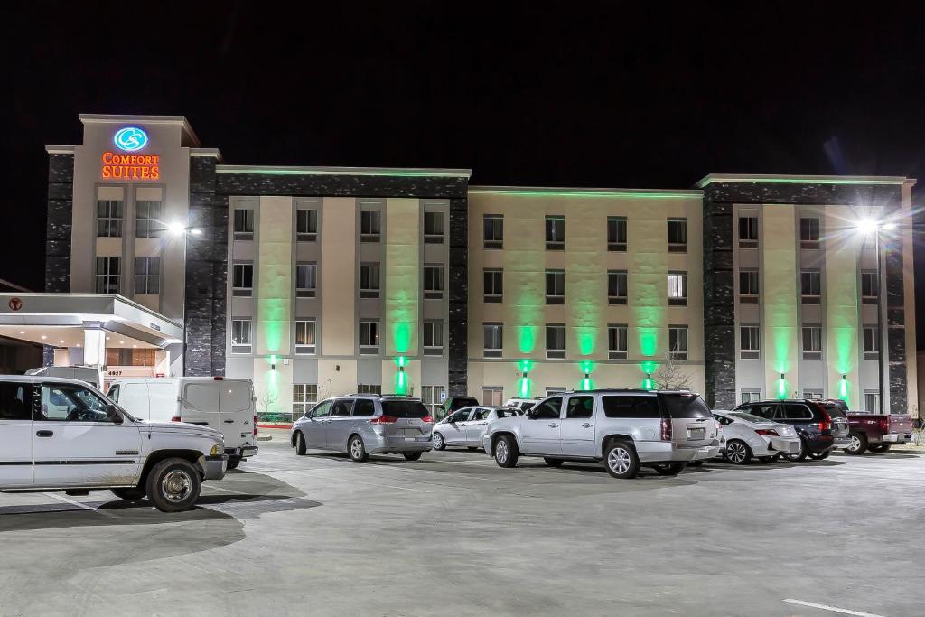 a parking lot in front of a building at night at Comfort Suites - University in Lubbock