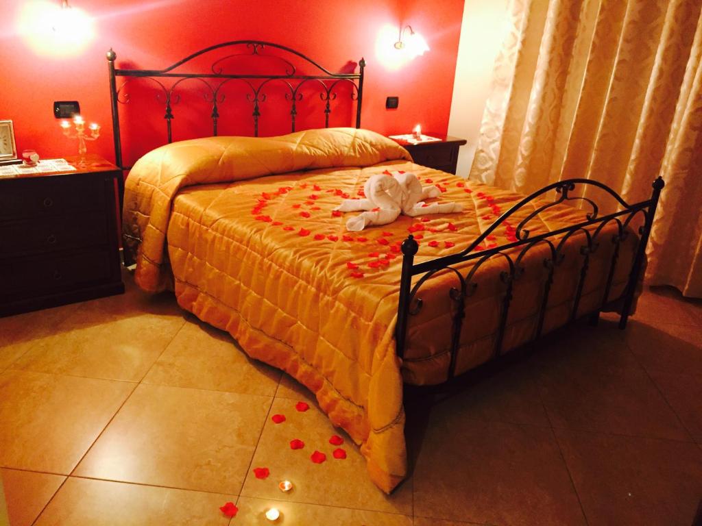 a bedroom with a bed with a stuffed animal on it at Agriturismo "LE ANFORE" in Ariano Irpino