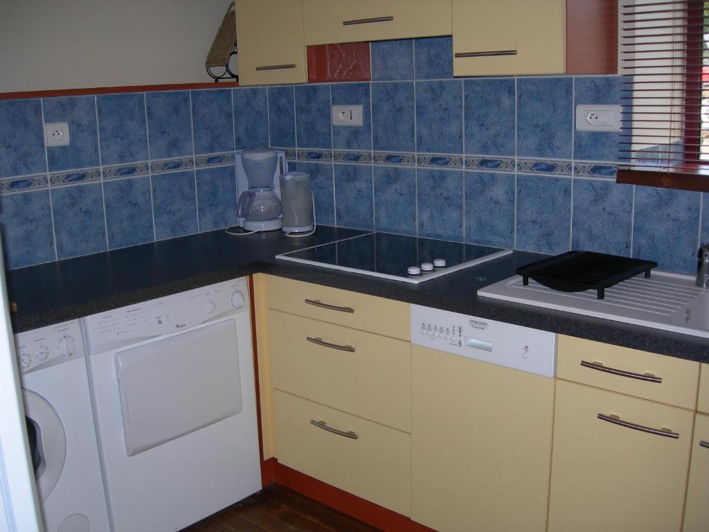 una cocina con fregadero y estufa horno superior en la maison de Léa, en Cancale