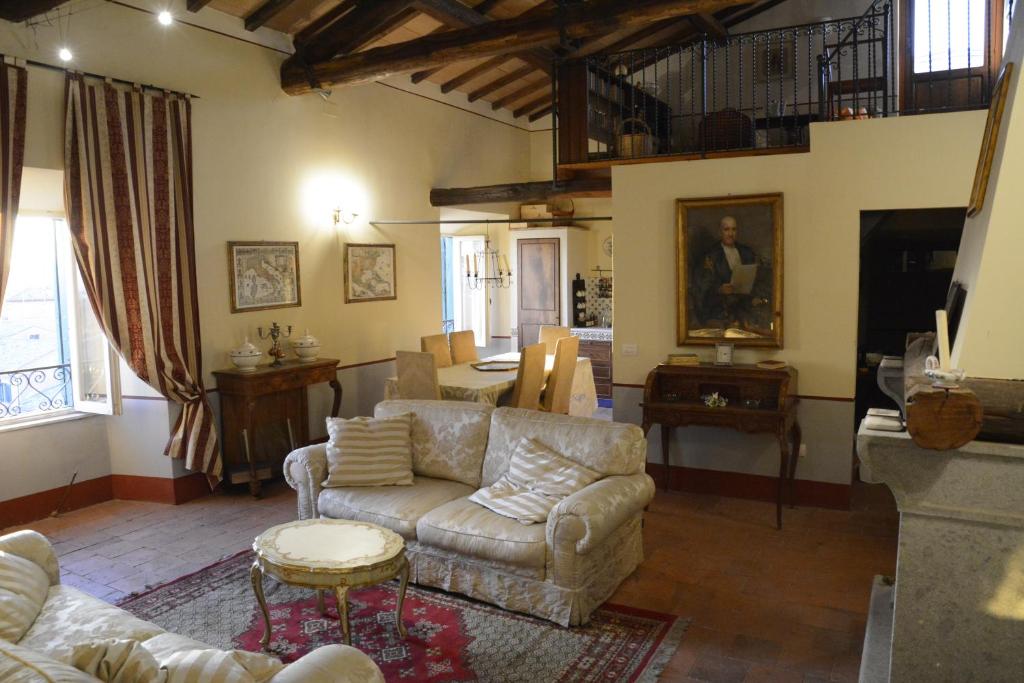 a living room with a couch and a table at Attico Panoramico in dimora storica in Canino