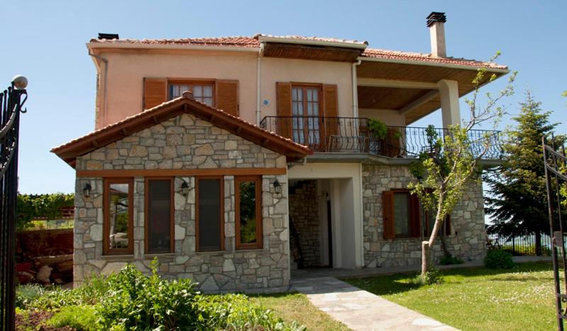 a house with a balcony on top of it at To Balkoni tis Limnis Plastira in Neochori