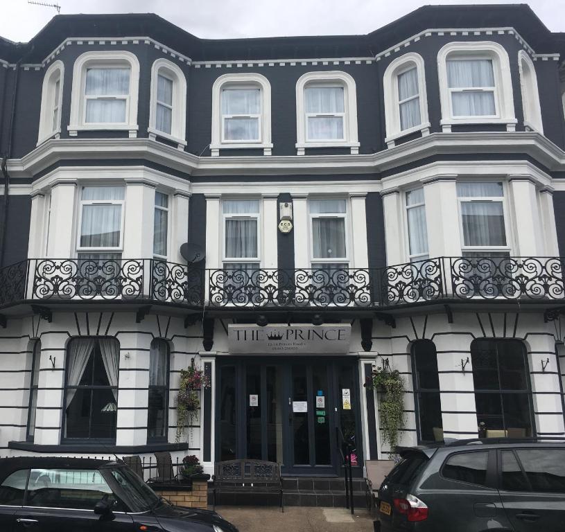 a black and white building with a balcony at The Prince Guest House in Great Yarmouth