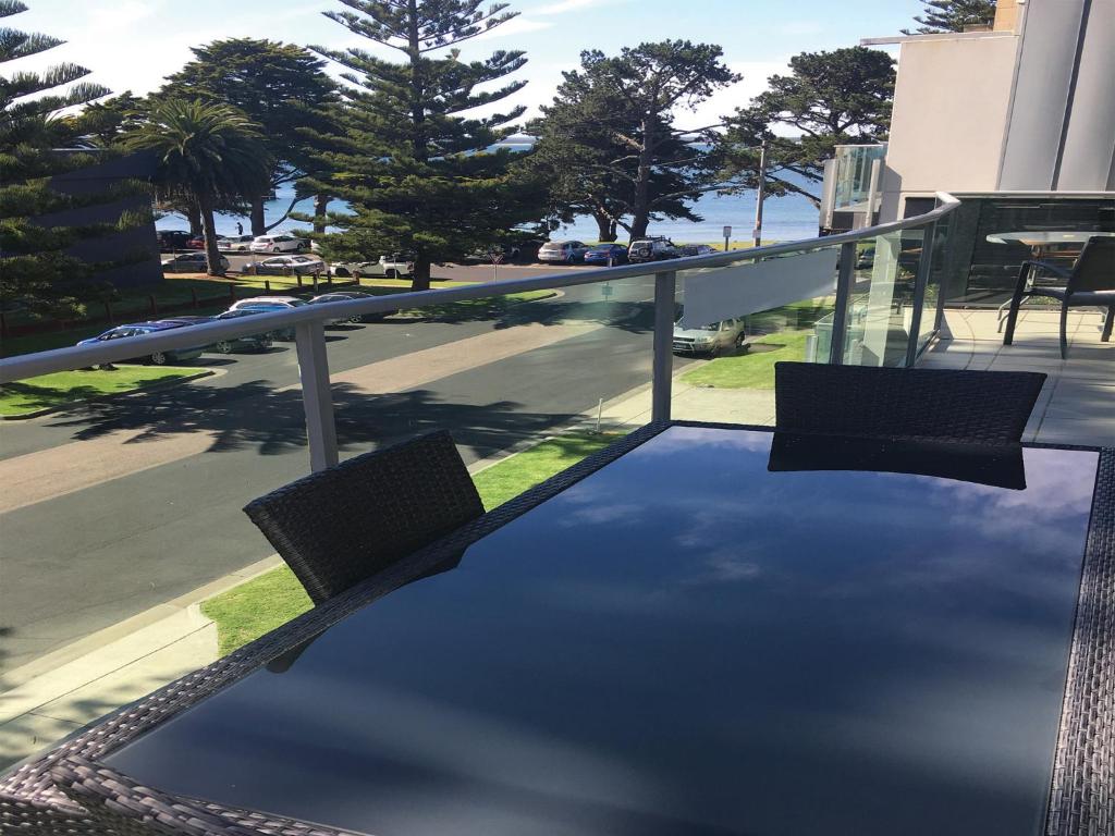 a balcony with a table and chairs on a roof at 507 At The Waves in Cowes