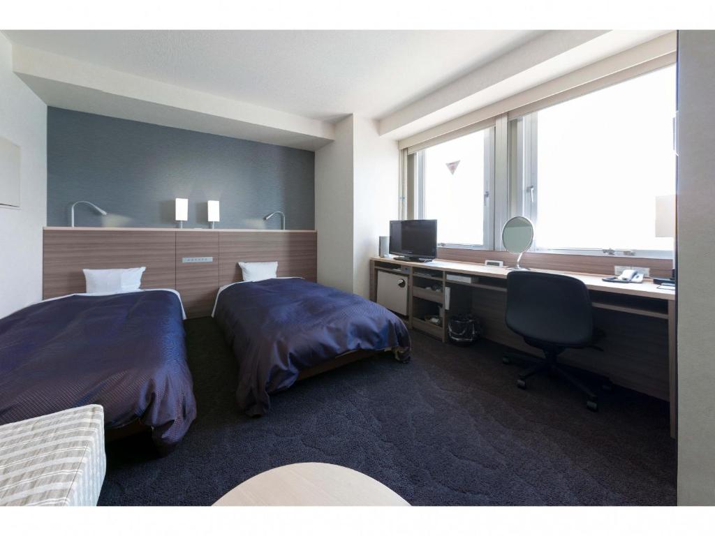 Voodi või voodid majutusasutuse Onomichi Daiichi Hotel toas