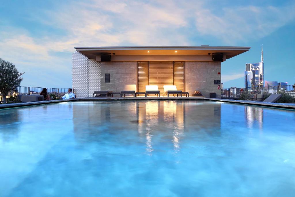 a swimming pool on the roof of a building at Hotel VIU Milan, a Member of Design Hotels in Milan