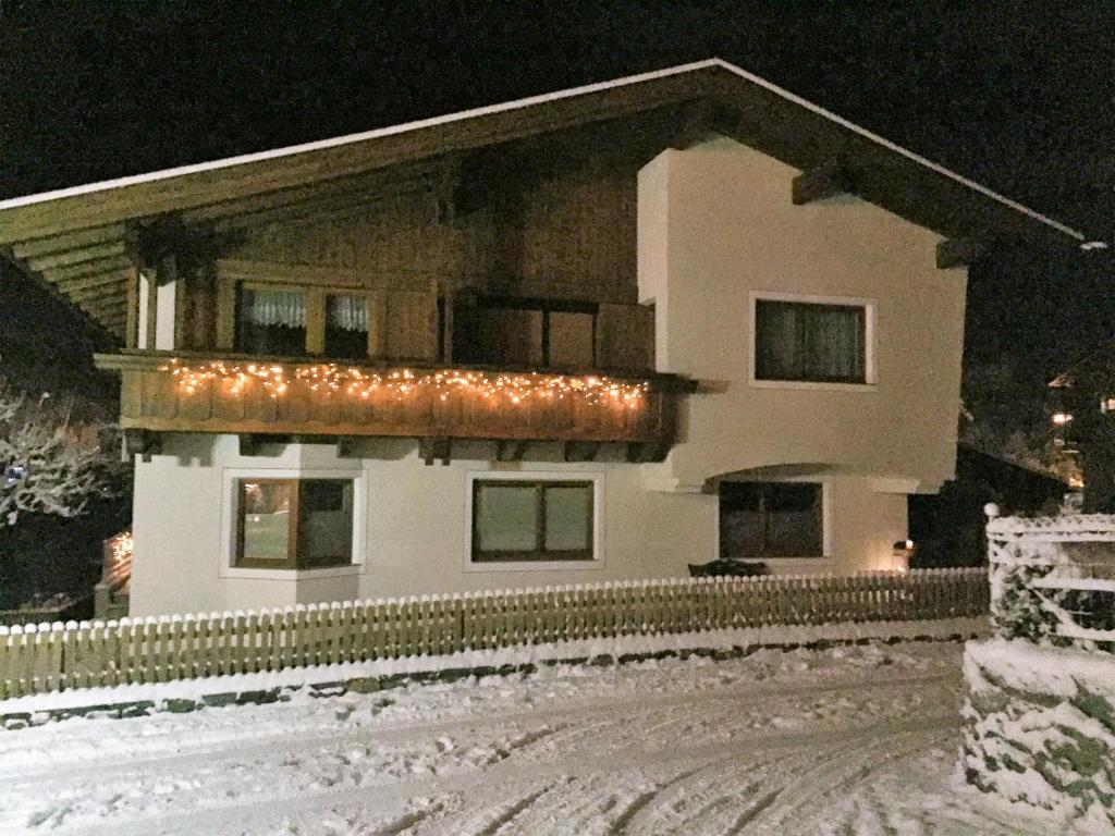 a house with lights on it in the snow at Haus Petrasch "555" in Pfunds