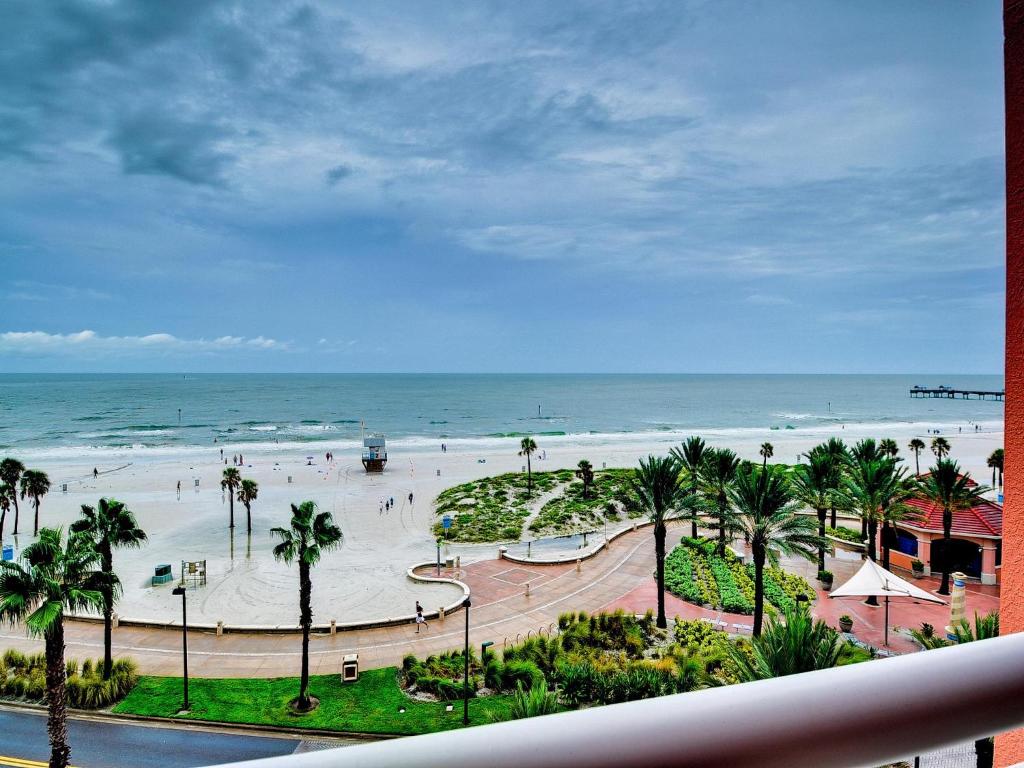 a view of a beach with palm trees and the ocean at Aqualea 504 in Clearwater Beach