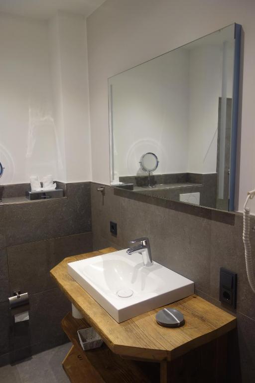 a bathroom with a sink and a large mirror at Haus Dumicketal in Drolshagen