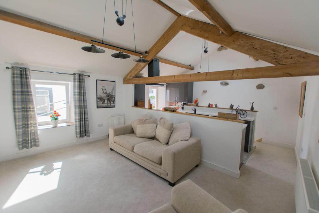 a living room with a couch and a fireplace at Red Rose Cottage in Cockermouth