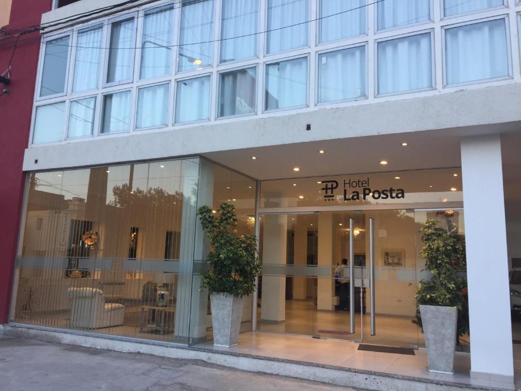 a store front of a building with large windows at Hotel La Posta in Oncativo