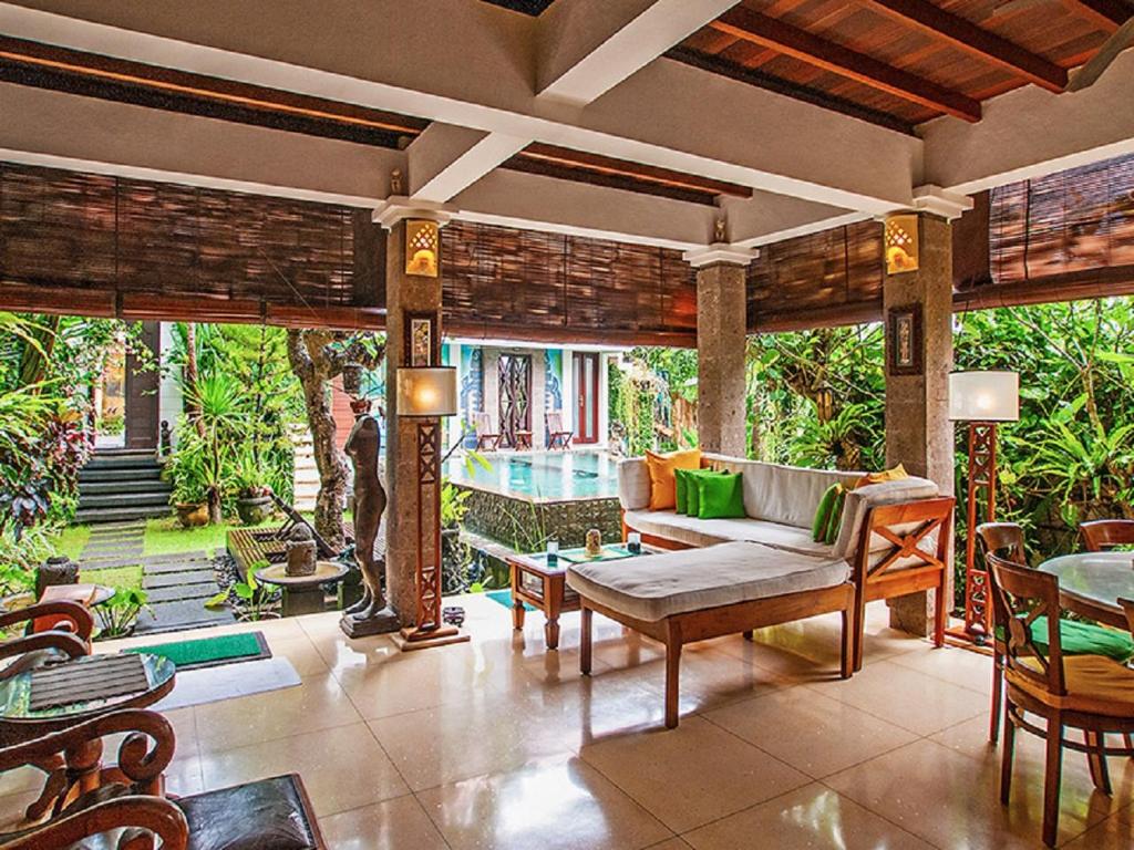 a living room with a couch and a table at Umah Watu Villas in Seminyak