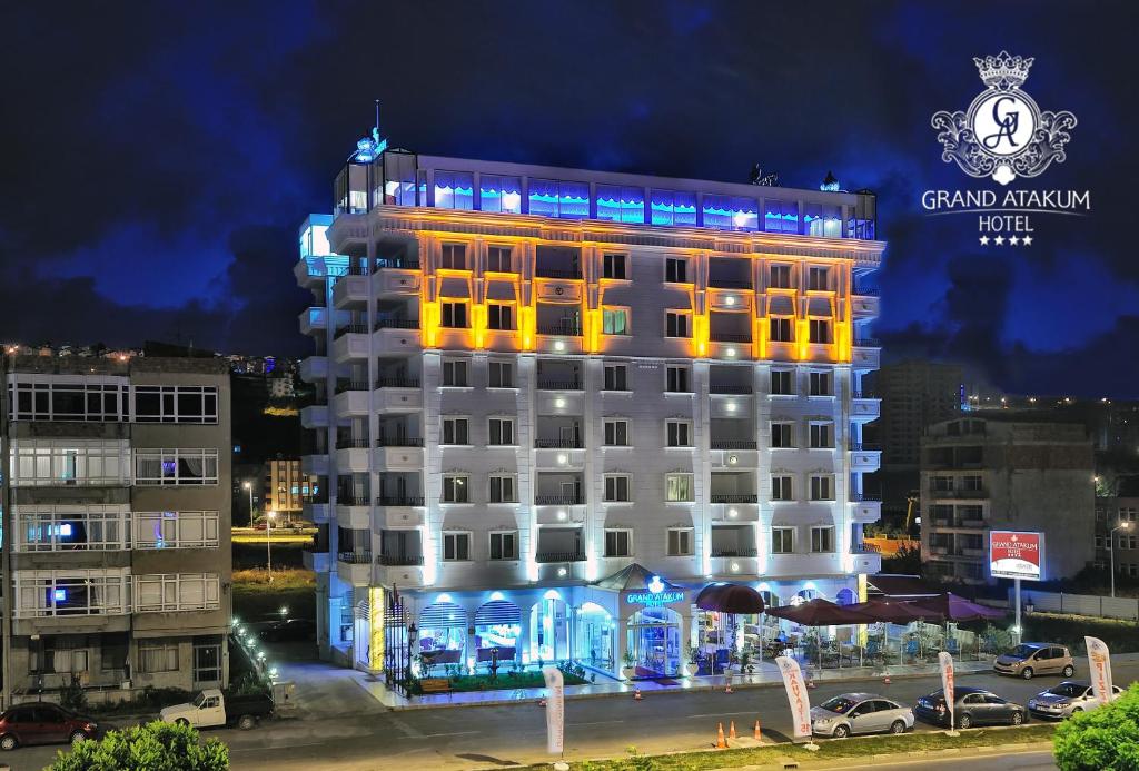 a building with a sign on top of it at Grand Atakum Hotel in Samsun