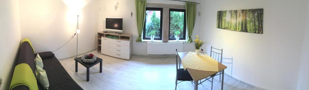 a living room with a table and a television at Ferienwohnung Kramer in Colnrade