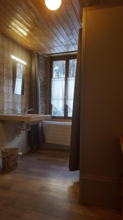 a bathroom with a sink and a window at Aiguille de La Tza in Arolla
