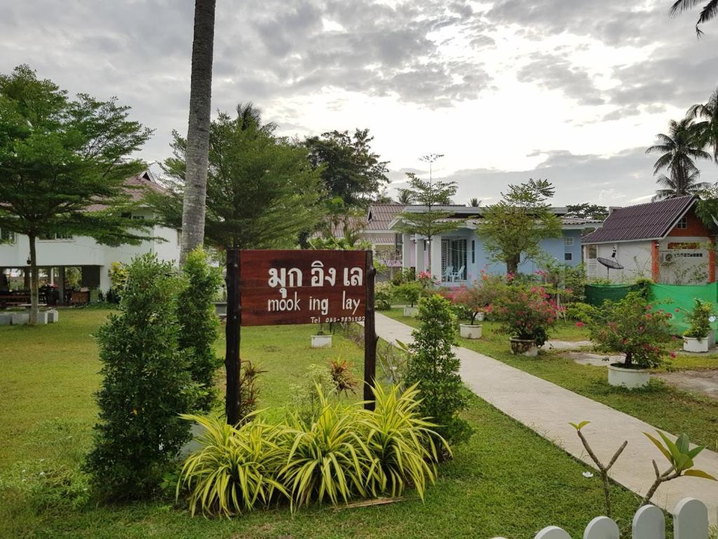a sign in a yard next to a sidewalk at Mook Ing Lay in Ko Mook
