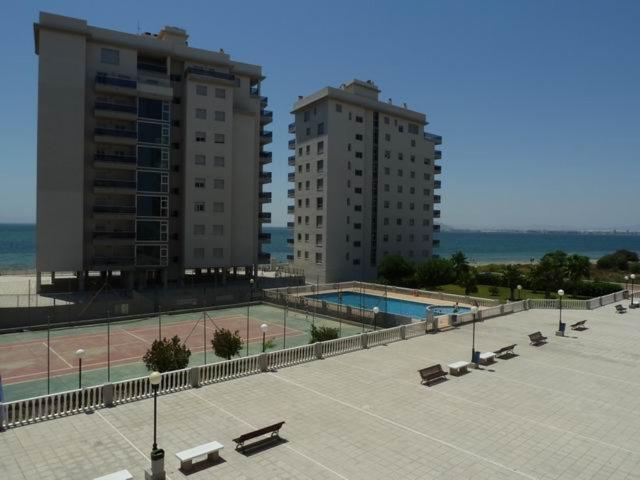 un patio con piscina y 2 edificios altos en Apartamento la manga, en La Manga del Mar Menor