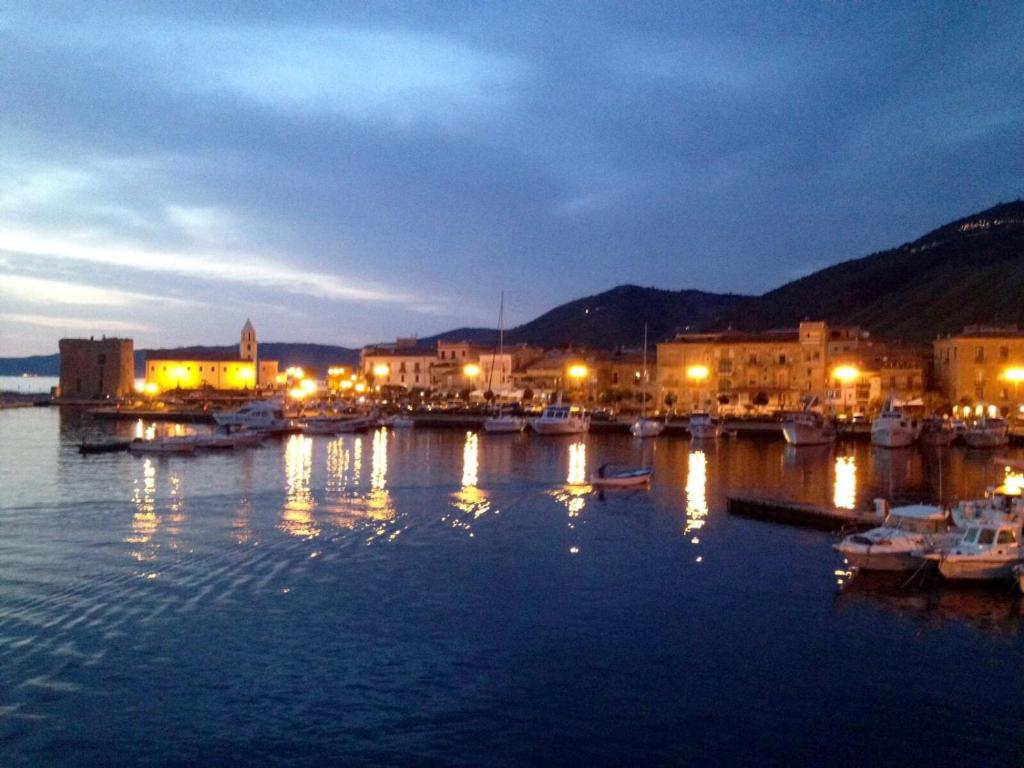 a harbor with boats in the water at night at Into lupene in Acciaroli