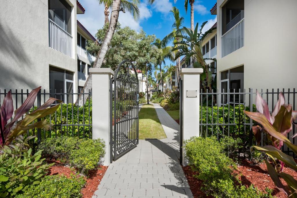a gate at the entrance to a villa with palm trees at Bellasera Resort in Naples